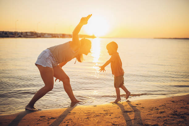 istock Woman playing with son by the sea 1731798308