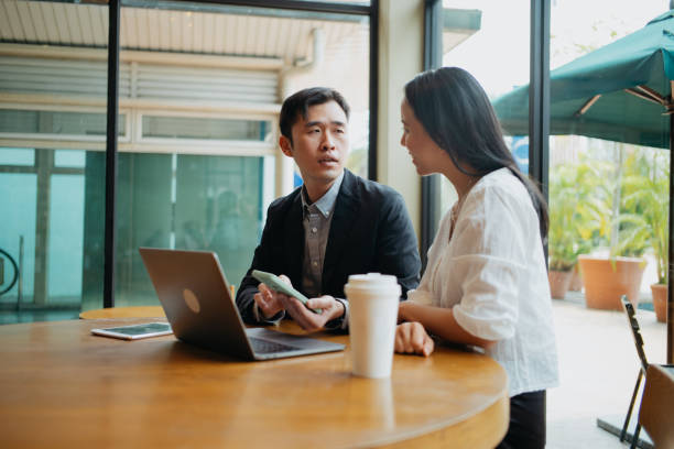 istock Insurance agent having discussion with client in cafe 1731803223