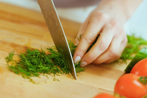 istock Closeup on housewife cutting fresh dill 1731812366