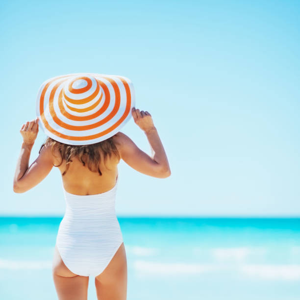 istock young woman on beach. rear view 1731818328