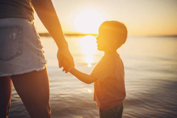 istock Woman standing with son by the sea 1731818334