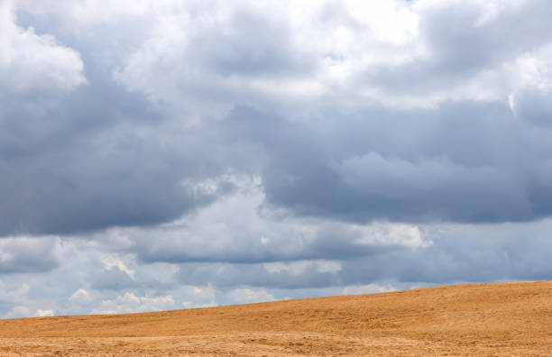 Countryside desolate alone tranquility. Rural landscape. Dramatic sky with clouds. Beautiful natural landscape in the summer time.