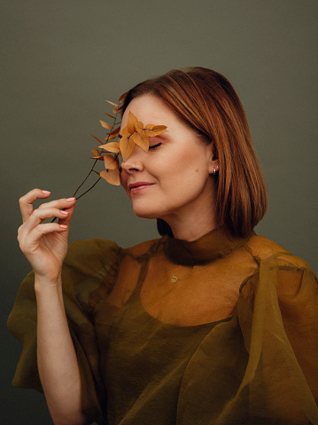 Serene autumn woman portrait in studio