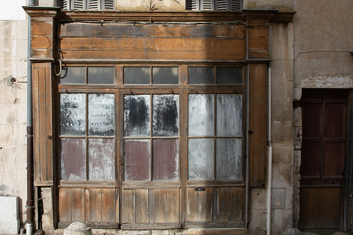 abandoned wooden facade of an old worn wooden shop entrance door store
