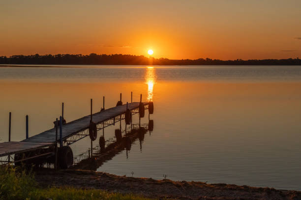 istock Orange summer sunset  with a dock and reflection at Ten Mile Lake. 1731887323