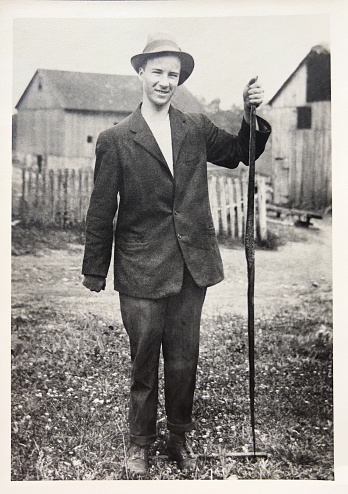 Old vintage photo of man dressed in the style of the day early 1900's.