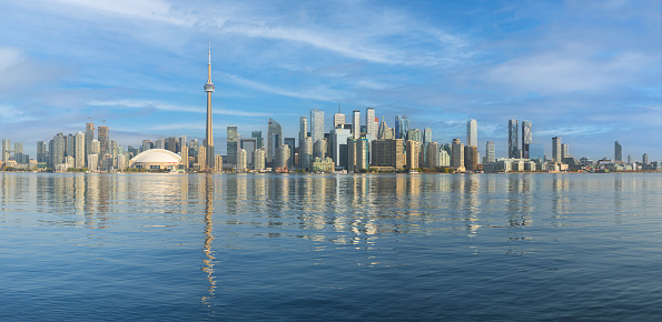 Toronto, Ontario, Canada - October 2, 2023: Panoramic view of Toronto skyline from Centre Island on calm day under blue sky