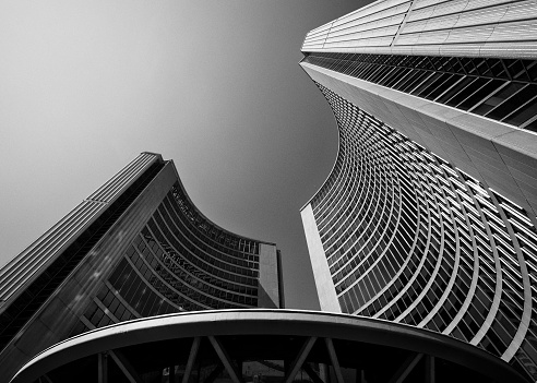 Toronto, Ontario, Canada - October 2, 2023: Looking up at the newer Toronto City Hall at 100 Queen St West in black and white
