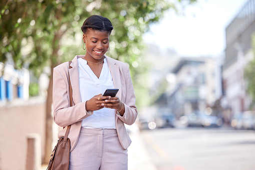 Business woman, phone and typing outdoor on a city road for communication, network or chat. Black female entrepreneur with a smartphone on a sidewalk for internet connection, message or travel app