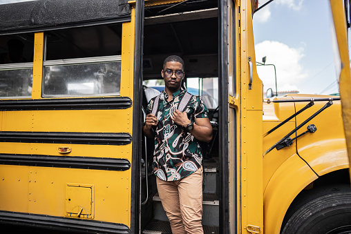 University student young man disembarking of school bus