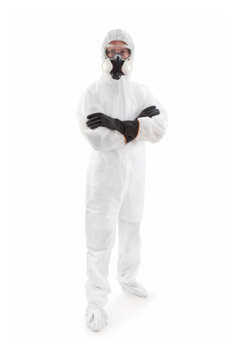 A scary looking man wearing a protective suit with goggles and gas mask. Isolated On White.