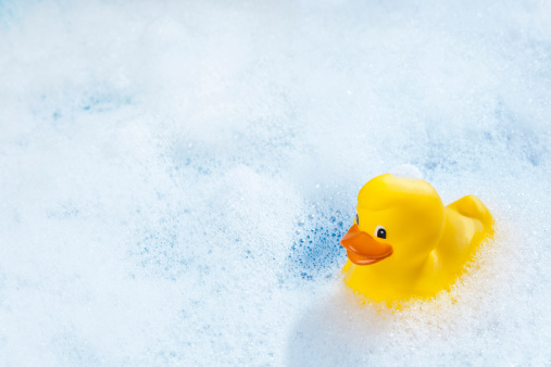 A yellow rubber duck in bathtub.