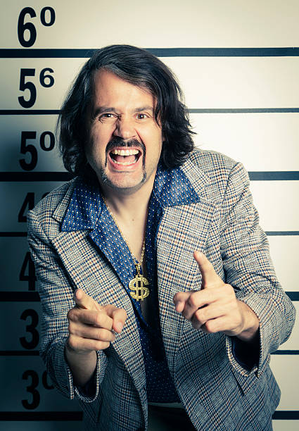 70's Guy Mugshot A police line-up mugshot of a man dressed in a 70's style outfit.  Processed with a retro look. retro salesman stock pictures, royalty-free photos & images