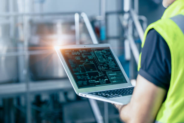 istock Engineer with laptop high technology software for industrial factory automation operate control service machine working monitor. 1731958925