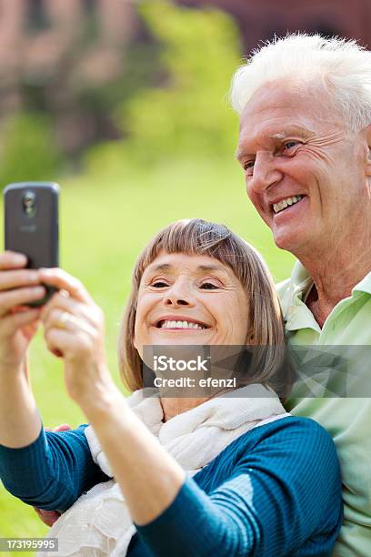 Mature Couple Taking Pictures With Smartphone Stock Photo - Download Image Now - Active Seniors, Adult, Adults Only