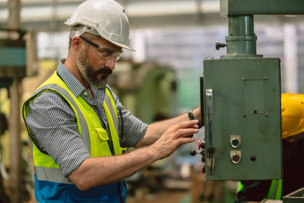 istock Senior hispanic engineer male expert worker work operate metal lathe milling machine in heavy industry factory 1731962117