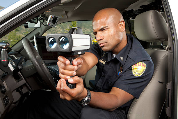 istock Police Officer checking vehicle speed with radar gun 173198006
