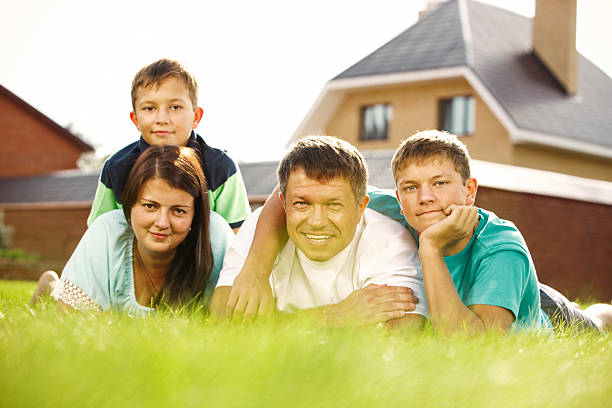 istock Family with two children lying on grass 173198293