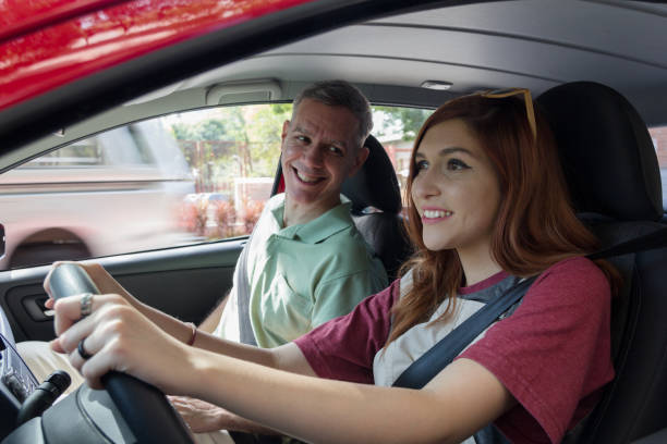 istock dad teaching daughter to drive 1731989961