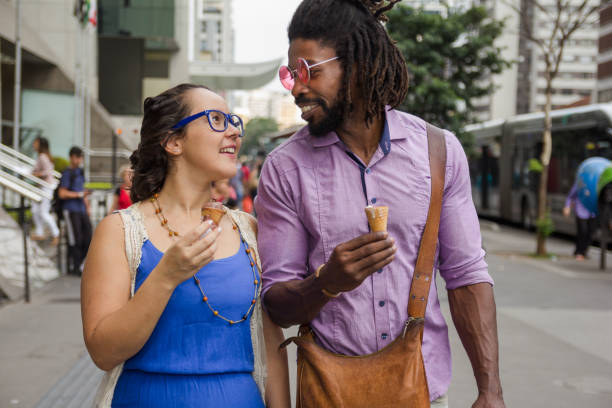 Romantic couple eating ice cream cone.