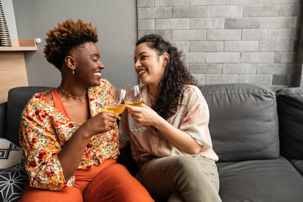 istock lesbian couple toasting with wine at home 1731991627