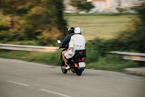 Two people in motion on a scooter
