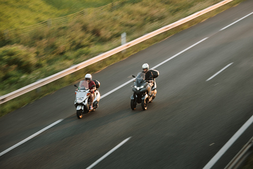 Two motorbikes in motion on a highway