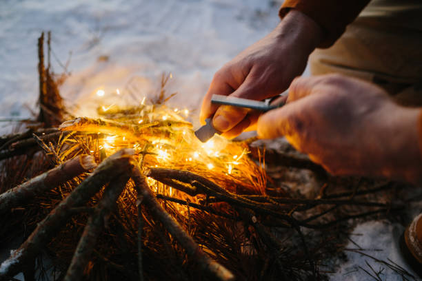 istock Male hand starts fire with magnesium fire steel, fire striker 1732016317