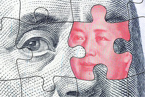 A complex jigsaw puzzle featuring faces of Benjamin Franklin and Mao Zedong symbolizes the intricate trade war conflict and tension between USA and China, specifically in the realm of semiconductor.