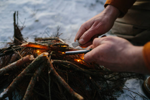 istock Male hand starts fire with magnesium fire steel, fire striker 1732016328