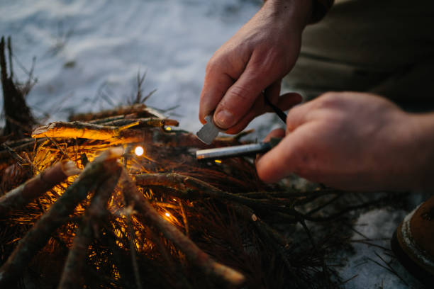 istock Male hand starts fire with magnesium fire steel, fire striker 1732016331