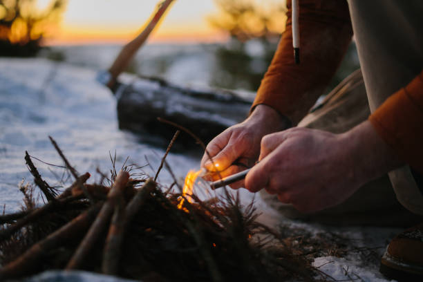 istock A tourist is making camp fire in the winter woods. 1732016338