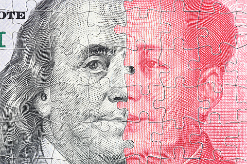 A complex jigsaw puzzle featuring faces of Benjamin Franklin and Mao Zedong symbolizes the intricate trade war conflict and tension between USA and China, specifically in the realm of semiconductor.