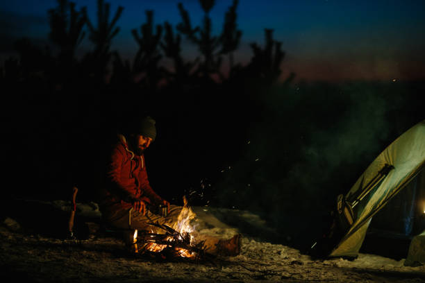 istock A bearded young man makes delicious coffee on a bonfire while enjoying the sunset in a winter forest. The concept of survival and hiking in the wild. 1732017454