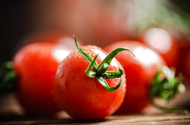Fresh tomatoes. On wooden table.