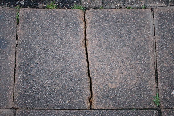 istock Aerial view of broken cracked slab on sidewalk 1732031705