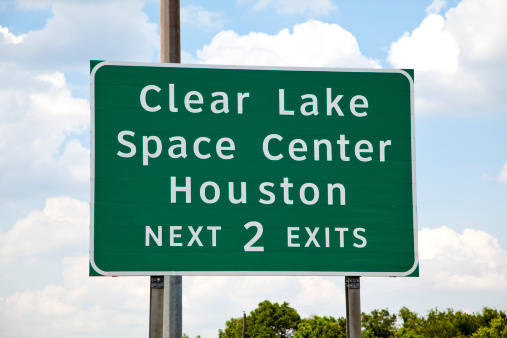 Texas highway sign showing exit to Clear Lake and Space Center Houston.