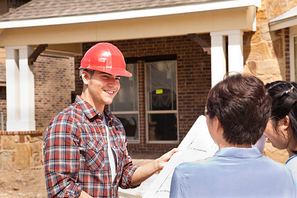 istock Builder meeting with woman and daughter at new home construction 173203485