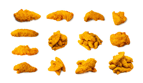 Chicken strips pile isolated. Breaded nuggets, crispy fry chicken breast, boneless meat, american deep fried crunchy fillet pieces on white background top view