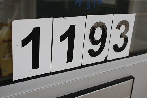 Door Numbers 1193 attached to a glass door, taken at an angle