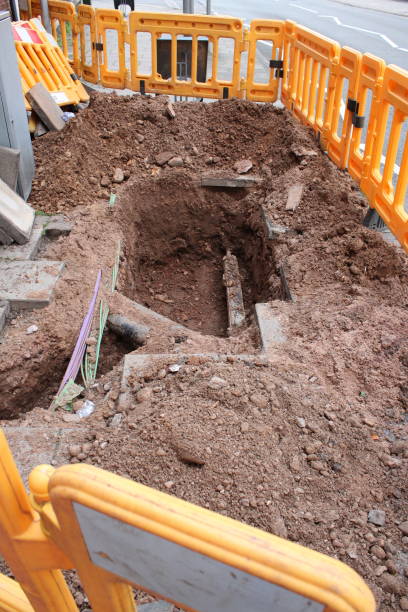 istock Pavement dug up with exposed utility pipe and electrical cables 1732037079