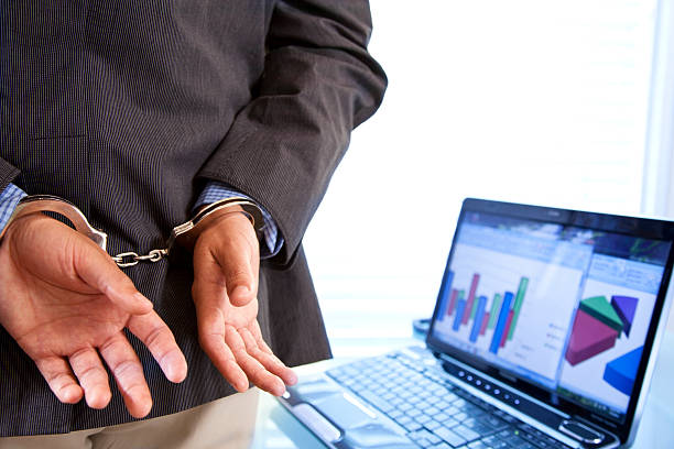 White collar Crime.  Businessman in handcuffs. White collar Crime.  Businessman in handcuffs. white collar crime handcuffs stock pictures, royalty-free photos & images