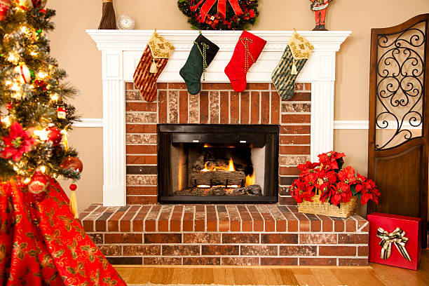 Traditional fireplace with stocking, wreath and Christmas tree
