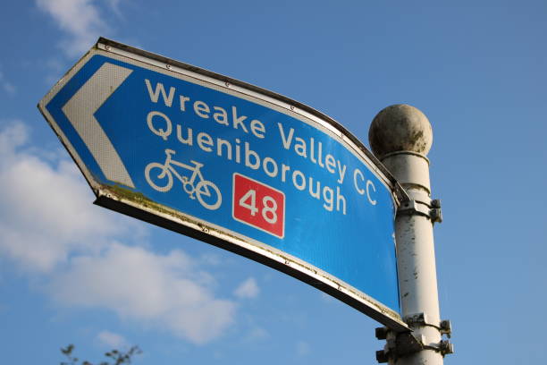 istock Bent damaged blue village sign post 1732044669