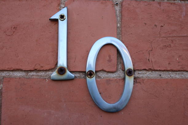 istock Silver door sign number 10 digits with rusty screws UK 1732049116
