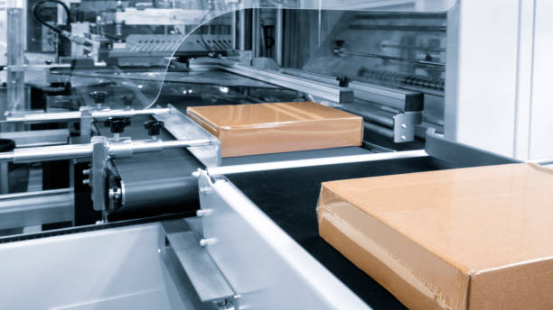 istock Automatic industrial machine for plastic packaging with light effect of products and food. automated packaging line with plastic film in a light blue scene. machinery product packaging concept 1732050415
