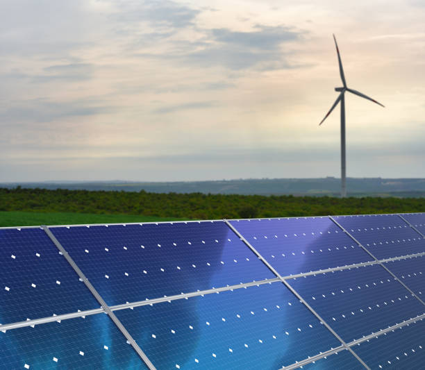 istock Solar panels and wind turbines in a field 1732052083