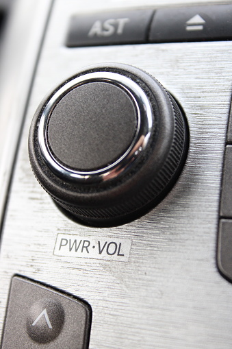 Volume control dial from a car sound system, up close picture, inside car