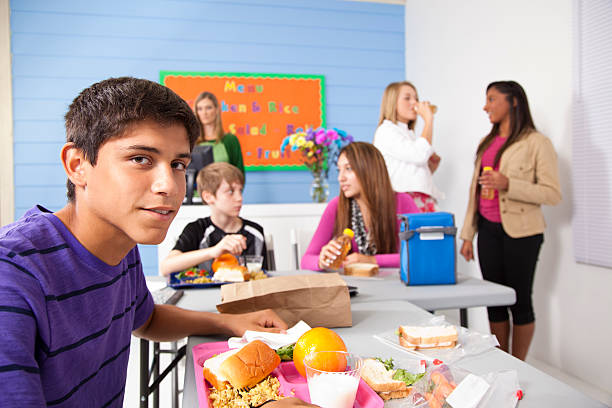 istock Teens in school cafeteria eating lunch.  Menu on wall 173205214