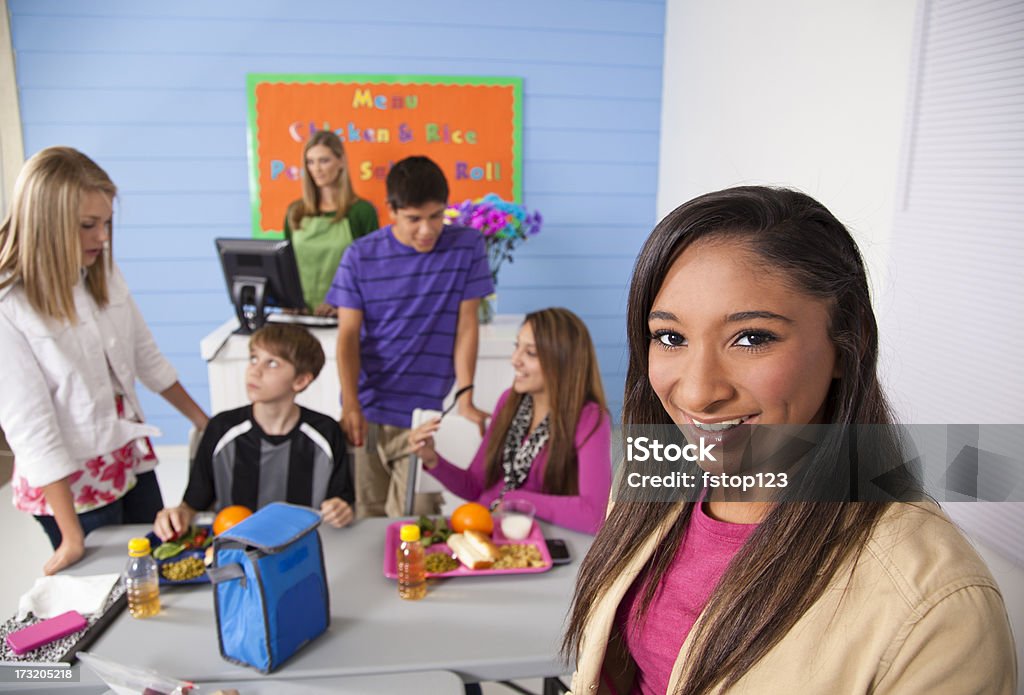 Adolescentes en la escuela cafeteria comer el almuerzo. Menú en pared - Foto de stock de 12-13 años libre de derechos